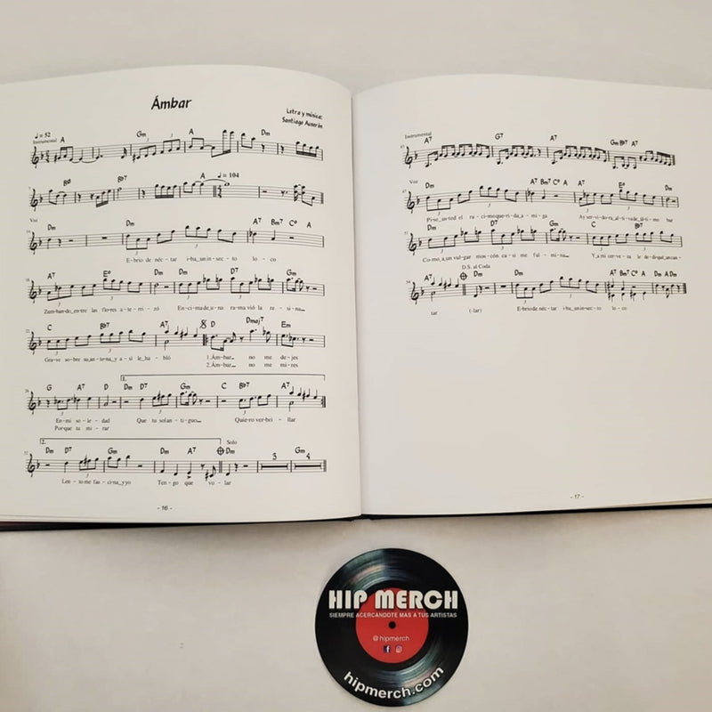 Fotografía de las páginas abiertas del libro de Juan Perro que muestra las partituras musicales de las canciones incluidas en el álbum.