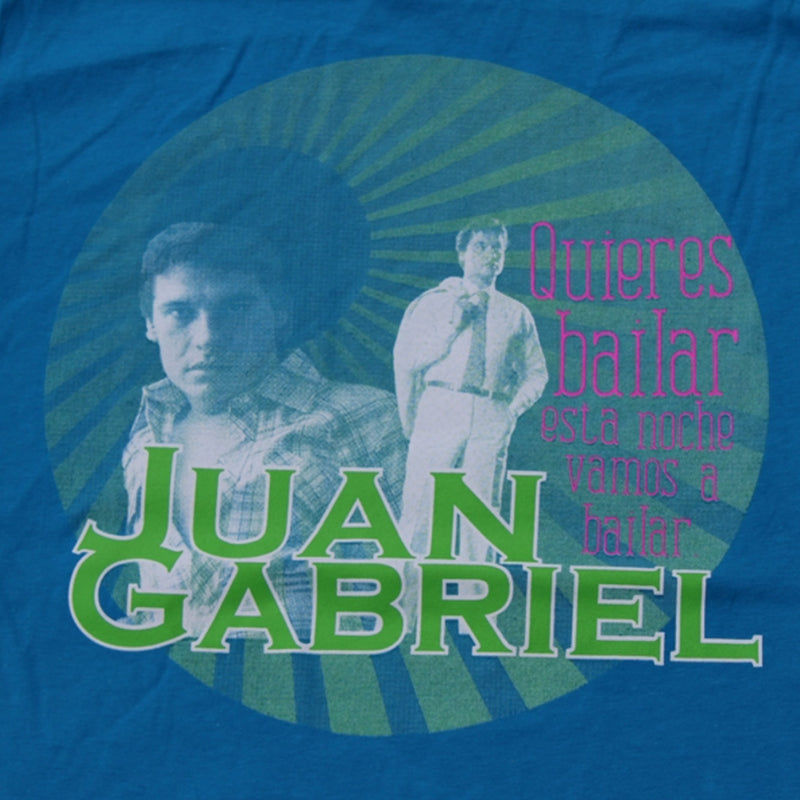 Acercamiento detallado al diseño circular verde de la playera que muestra los retratos clásicos de Juan Gabriel y las letras de la canción.