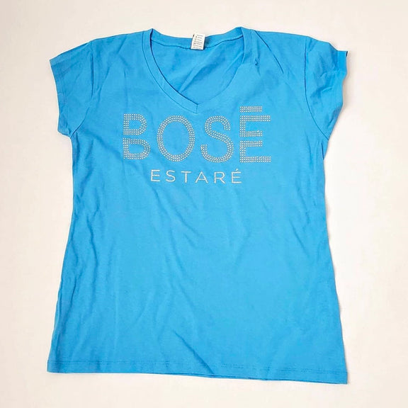 Fotografía de catálogo de la playera azul oficial de Miguel Bosé con corte para mujer, mostrando el diseño y ajuste del textil.