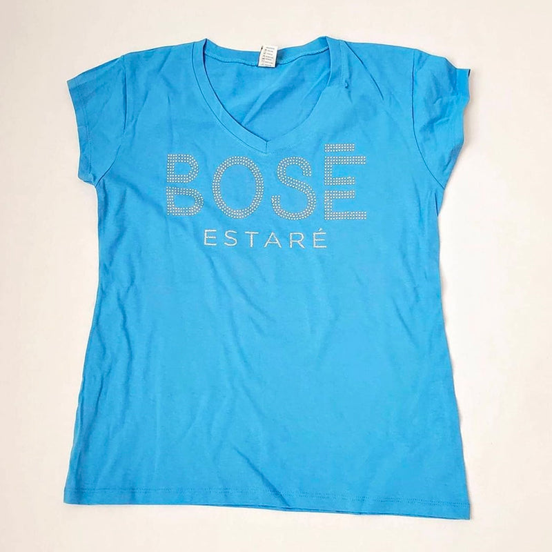 Fotografía de catálogo de la playera azul oficial de Miguel Bosé con corte para mujer, mostrando el diseño y ajuste del textil.