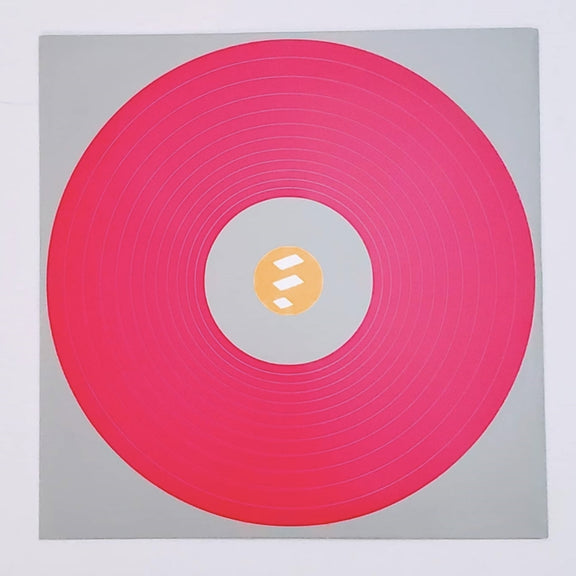 Fotografía del diseño gráfico interior complementario en forma de círculo rosa y blanco que acompaña la edición física del disco.