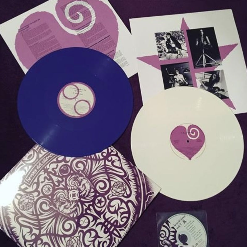 Fotografía del contenido de la edición especial del álbum Senda '91 de Héroes del Silencio, exhibiendo los dos discos de vinilo en colores blanco y púrpura junto a los insertos oficiales.